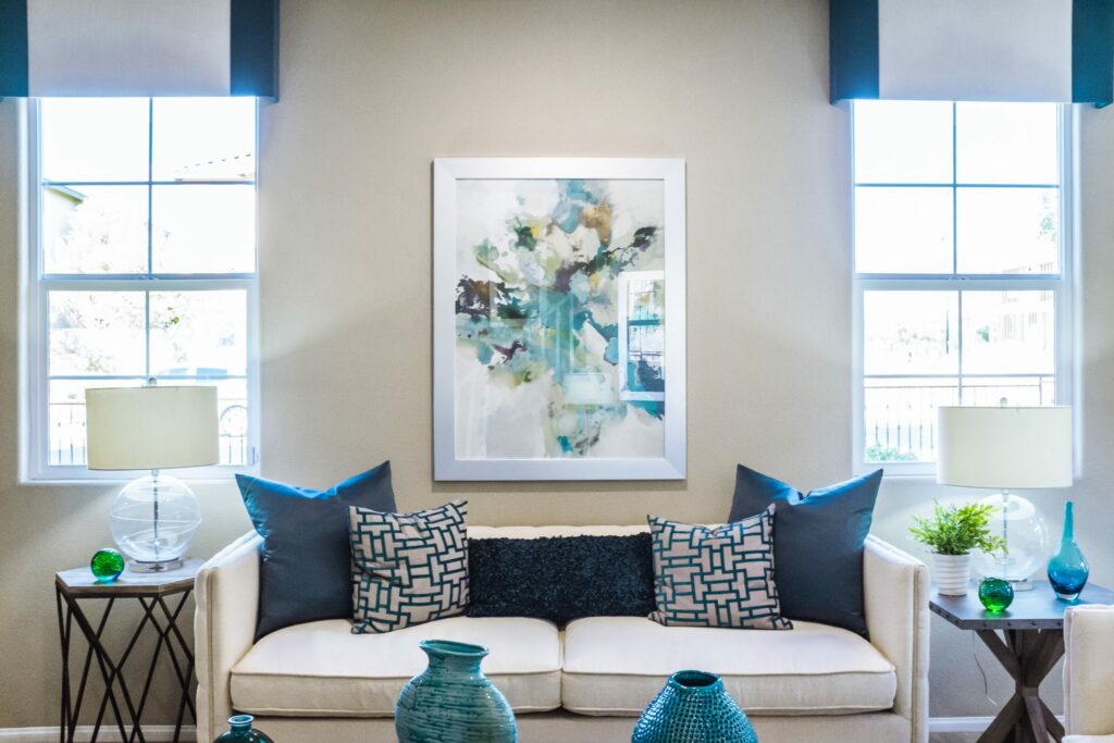 Upholstery Tampa white sofa in living room with blue throw pillows